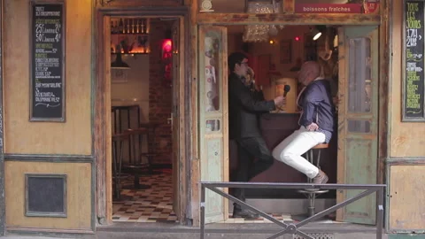 Man Being Interviewed with Microphone at Parisian Bar Entrance Exterior Shot 库存影片 347265604