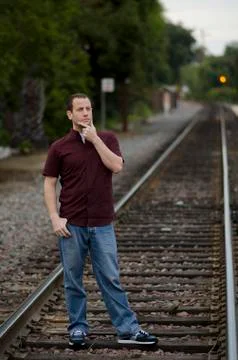 Man being optimistic about tomorrow on train tracks. Stock Photos