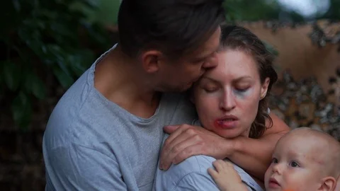 Man Being Physically Abusive Towards Family. Aggressor husband hugs his victim - Stock Footage 114109549