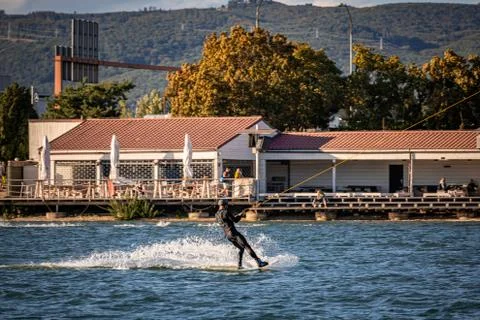 Man being pulled on a wakeboard on a lake Stock Photos