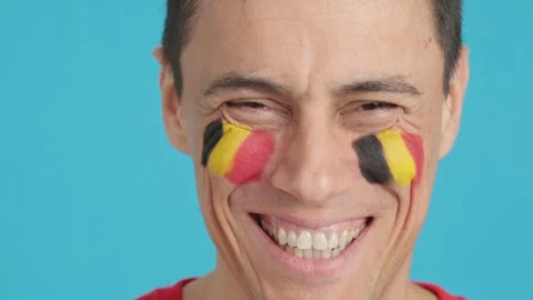 Man with a belgian flag painted on the face smiling Stock Footage 255525947