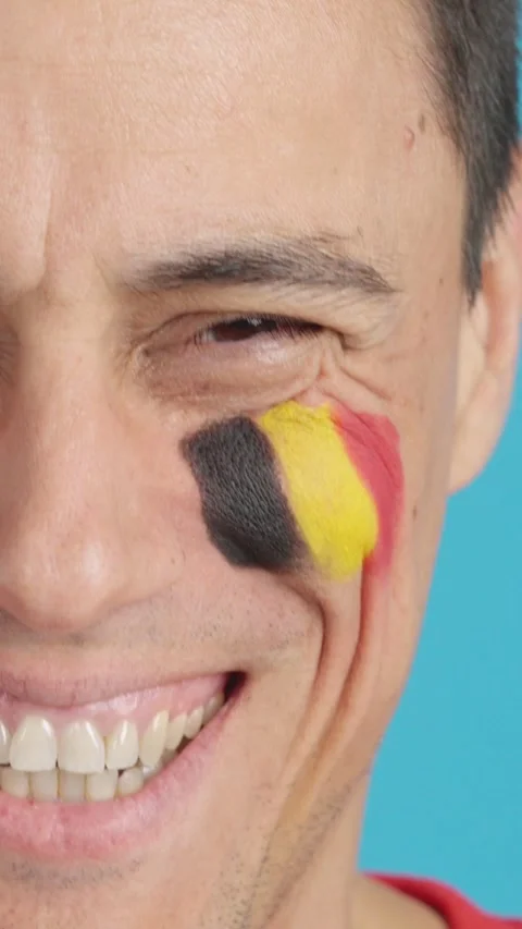 Man with a belgian flag painted on the face smiling Stock Footage 257310054