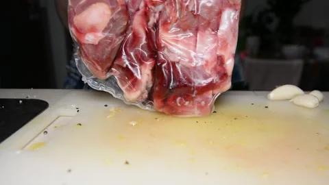 Man with belly sprinkles lamb meat with salt and pepper Stock Footage 130372190