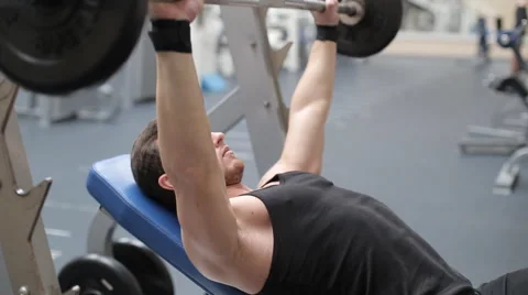 Man bench pressing weights Stock Footage 62562268