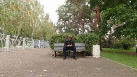 Man On Bench Take The Phone Stock Footage 162197900