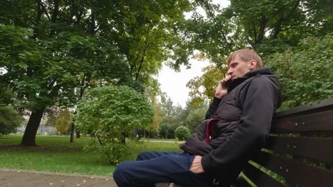 Man On A Bench Talking On Phone Stock Footage 162101684