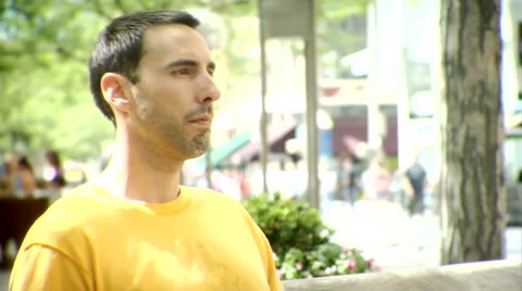 Man on Bench While Crowd Rushes By Stock Footage 6417178
