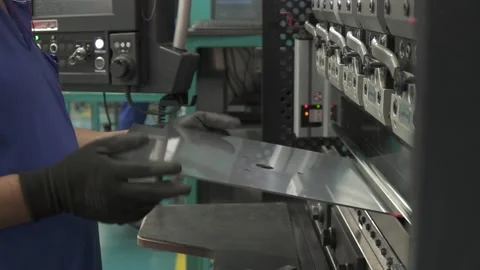 Man with a bending machine folding a peace of steel Stock Footage 247027275