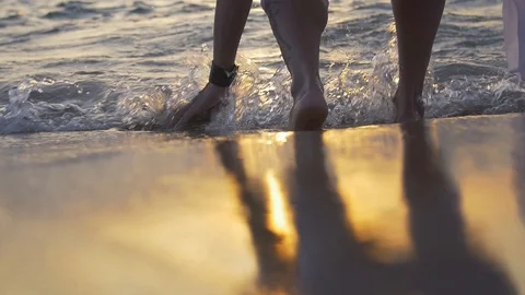 Man bends down to touch the water in slow motion Video stock 128074405