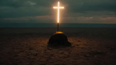 Man bent over praying under the cross Stock Footage 327979029