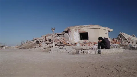 Man Beside Collapsed Building in Villa Epecuen Argentina After Disaster Stock Footage 337933967