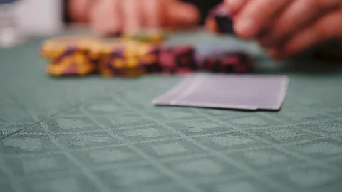 A man bets on chips while playing poker Stock Footage 124164695