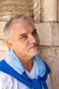 A man between 55 and 60 years old looking at the camera with a cheerful and.. Stock Photos