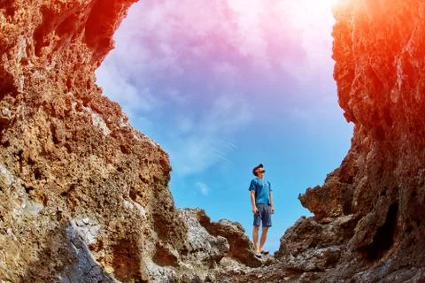 Man between the rocks on a background of bright blue sky Stock Photos
