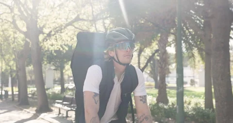 Man, bicycle and delivery with backpack in park for travel, package or parcel Vidéo 318252905