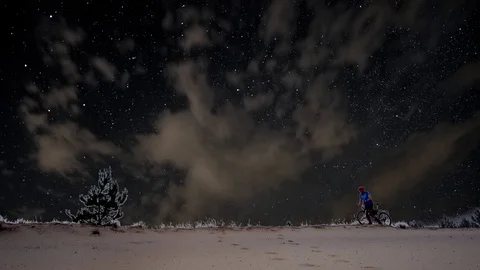 Man with a bicycle on a background of the starry sky Stock Footage 111566828