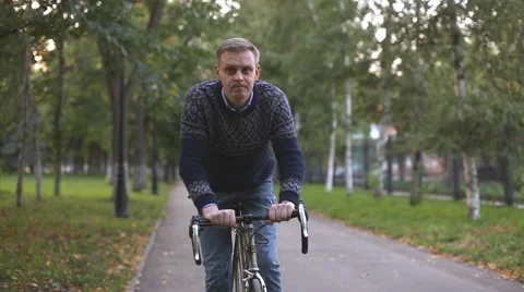 Man on a bicycle looking at his watch Stock Footage 54407882