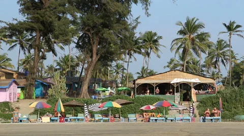 Man on bicycle passing by a beach bar in Goa. Stock Footage 49664383