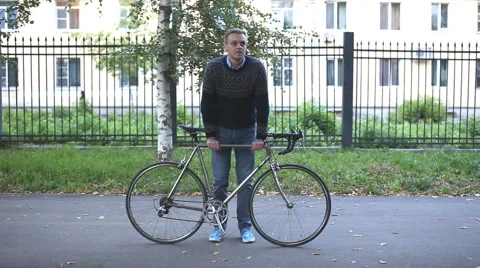 Man on bicycle resting in  park Stock Footage 54405228