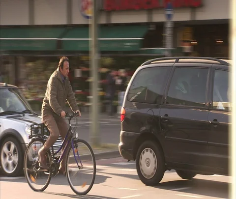 Man on bicycle rides with traffic Stock Footage 86742978