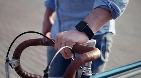 Man on a bicycle with a smart clock Stock Footage 55788881