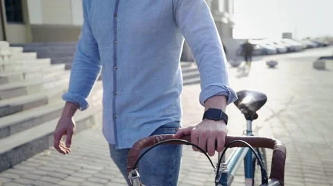 Man on a bicycle with a smart clock Stock Footage 55788977