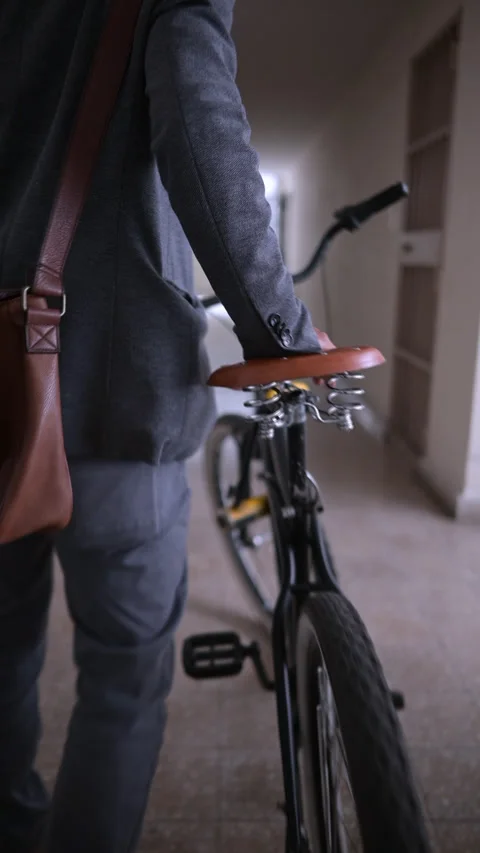 Man with a bicycle walks down the hallway of a building. Stock Footage 289909161