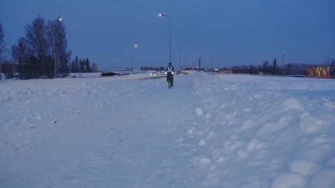 The man on a bicycle in a winter evening. Stock Footage 171655828