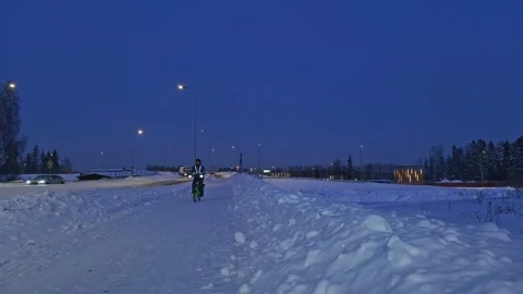 The man on a bicycle in a winter evening. Stock Footage 171655885
