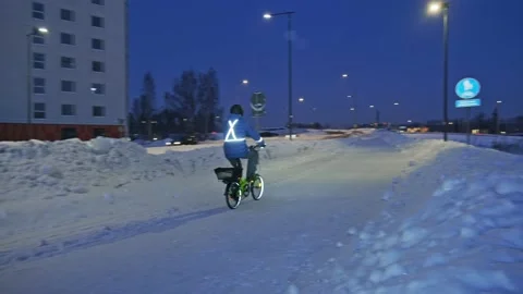 The man on a bicycle in a winter evening. Stock Footage 171655957