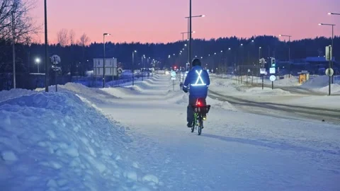 The man on a bicycle in a winter evening. Stock Footage 171655985
