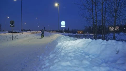 The man on a bicycle in a winter evening. Stock Footage 171655999