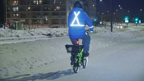 The man on a bicycle in a winter evening. Stock Footage 171656035
