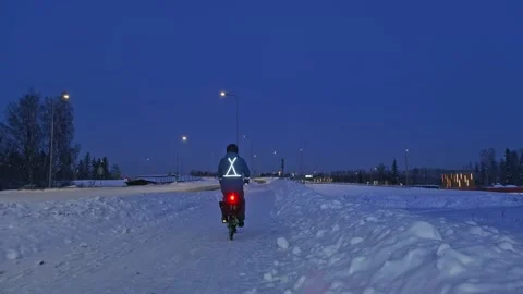 The man on a bicycle in a winter evening. Stock Footage 171656077