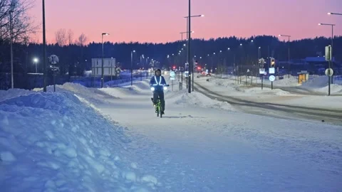 The man on a bicycle in a winter evening. Stock Footage 171656108