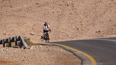 Man in bicycles training in the desert Stock Footage 102618397