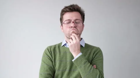 Man in big glasses trying to make a decision and solve problem. Stock Footage 119327366