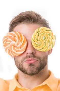 Man with big lollipops with hypnotizing pattern on eyes as eyeglasses Stock Photos