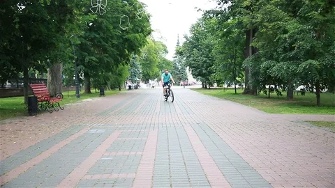 A man on a bike passing by Stock Footage 92633656