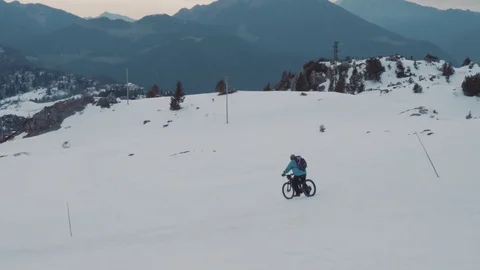 Man biking down on a snow hill. 4k Stock Footage 127490651