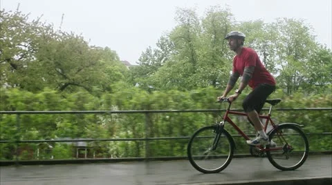 Man biking in a park Stock Footage 11340413