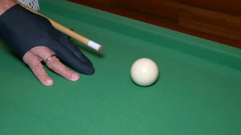 Man billiard player is aiming the cue ball with special gloves and cue. Stock Footage 208013396