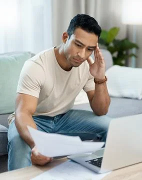 Man, bills and headache on computer and sofa for finance mistake, debt review or 写真素材