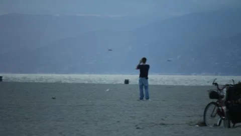 Man with Binoculars on Beach Stock Footage 11360552