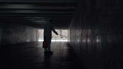 Man in bio-protective overalls spray a disinfector Stock-Footage 129437619