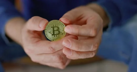 Man with bitcoin in his hands in closeup Stock Footage 238768414