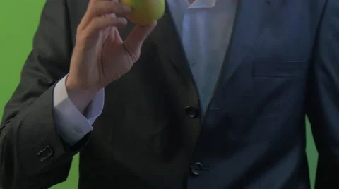 Man Bites an Apple Fruit in His Hand on a Green Screen Man's Hands Young Stock Footage 61038629