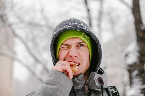 Man bites of bread on the street Stock Photos