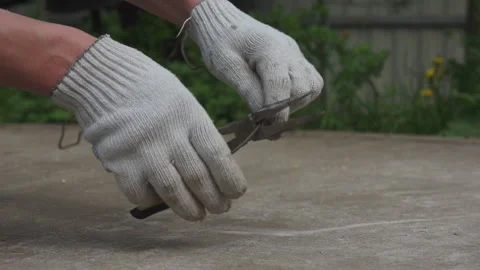A man bites off a wire with pliers. Hands in close up. Stock Footage 131258409