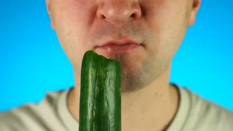 Man biting and eating cucumber. Close up of lower half male face, eating Stock Footage 167326745